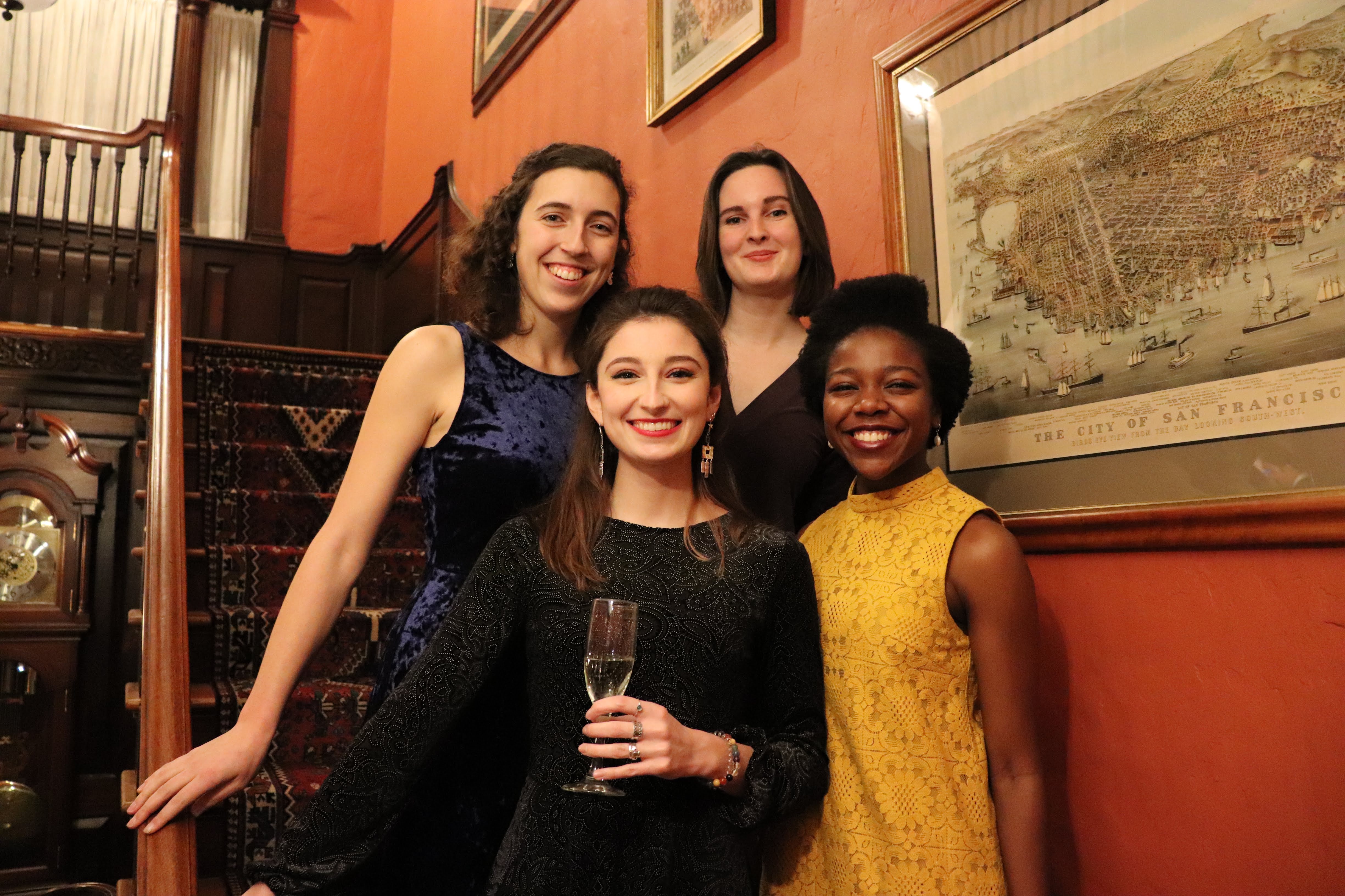 students posing for formal photos on faculty dean's staircase