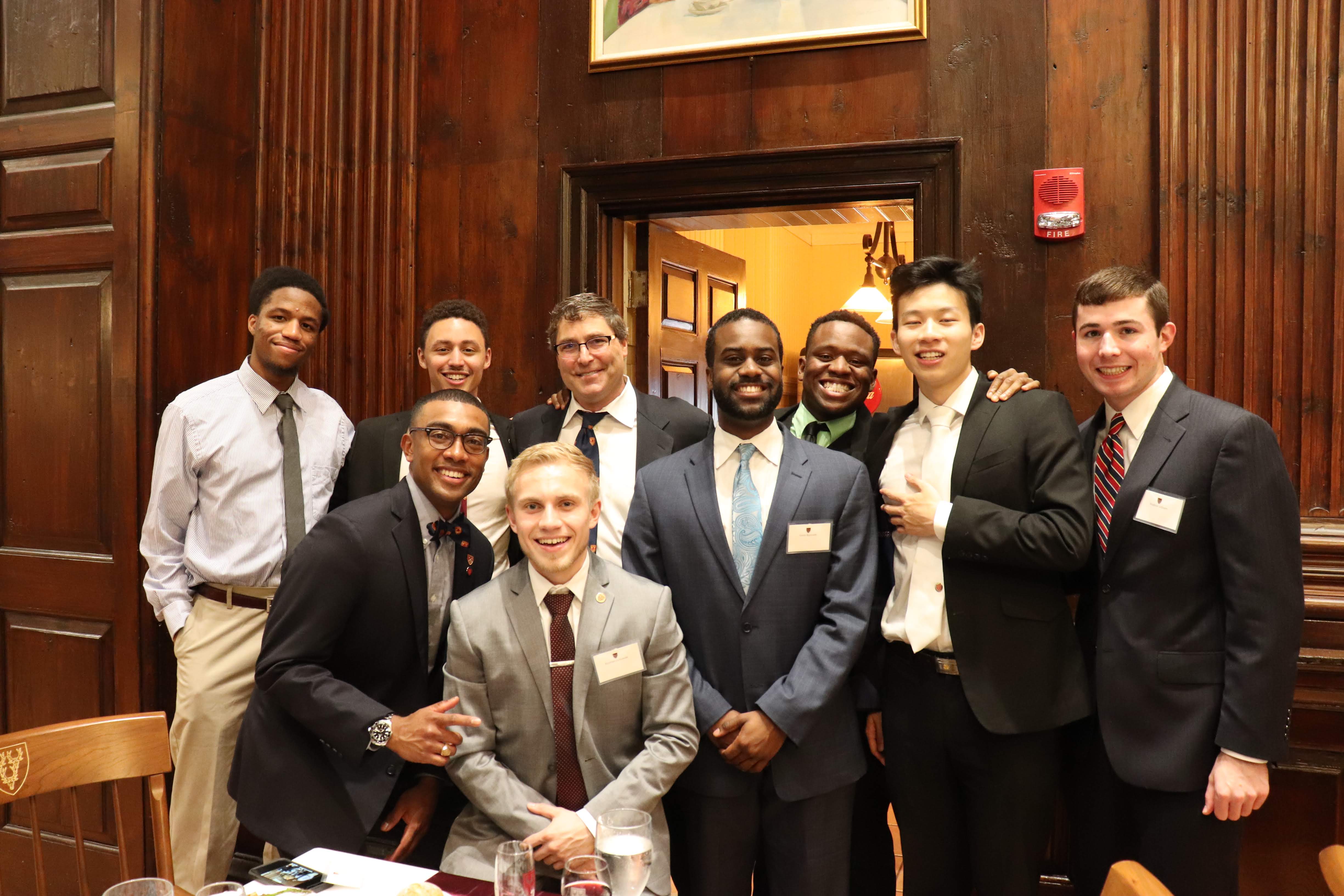 students smiling with Sean in dining hall