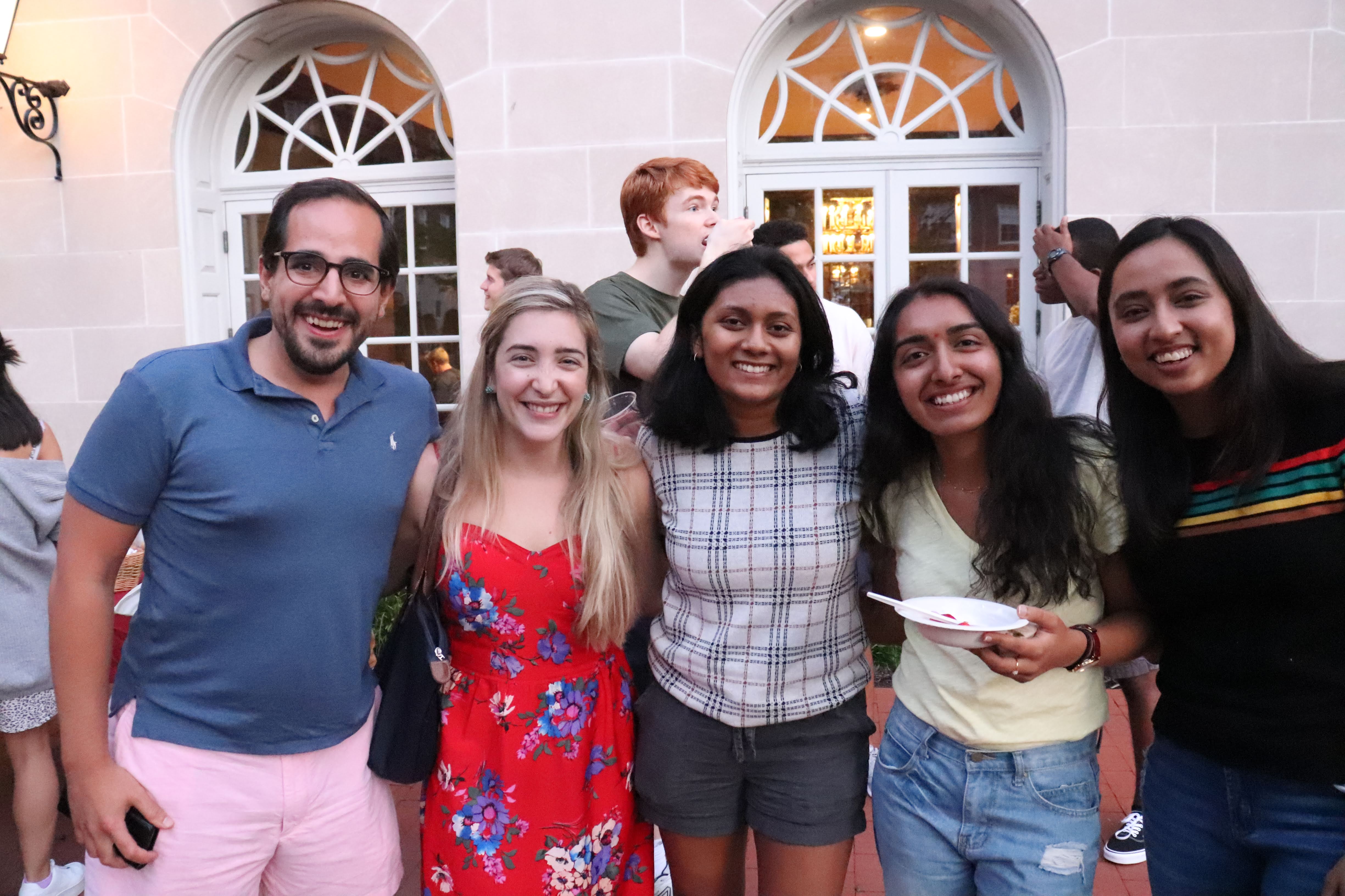 students and tutors smiling in Dunster courtyard