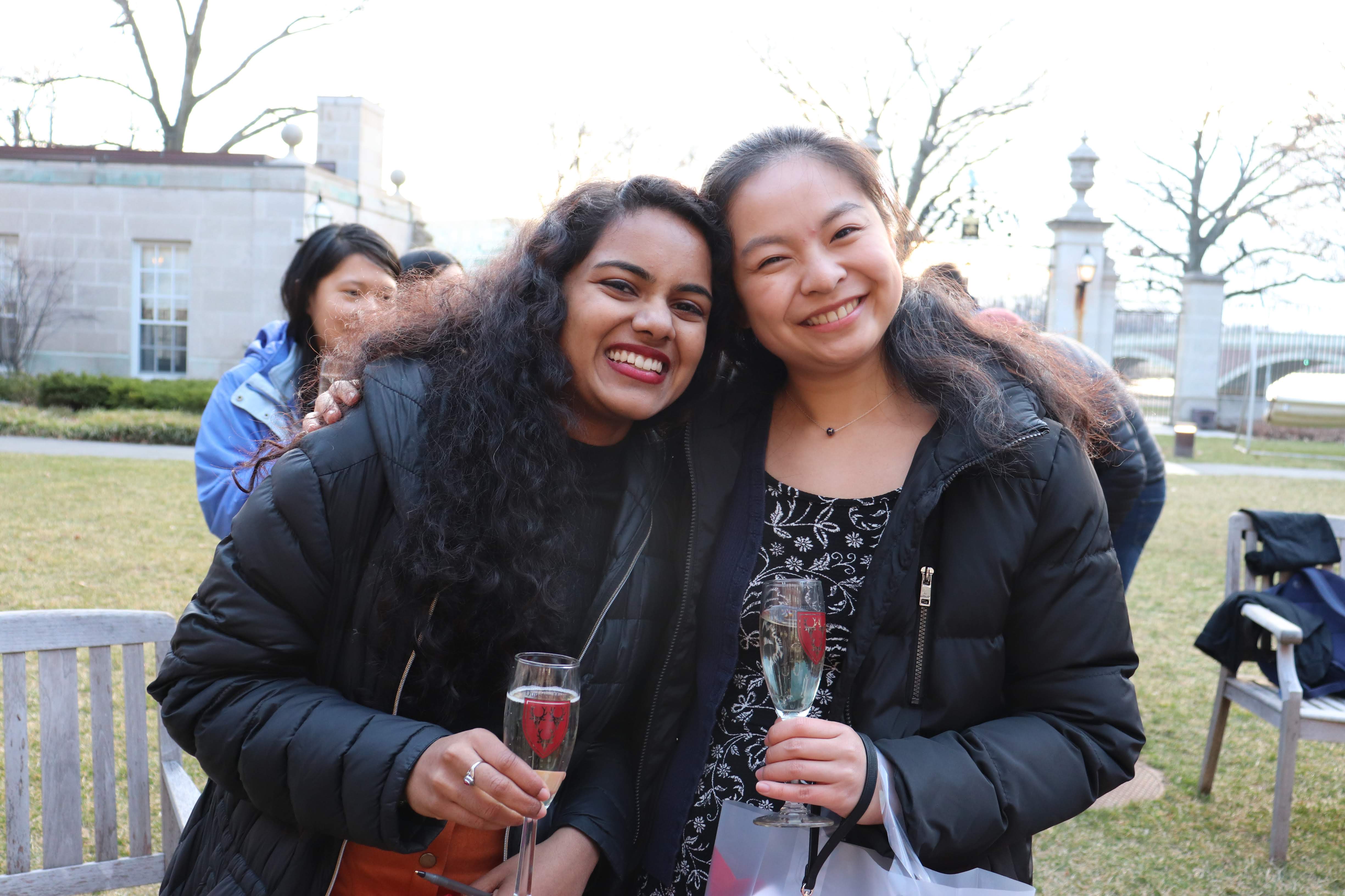dunster students with champagne glasses in Dunster courtyard