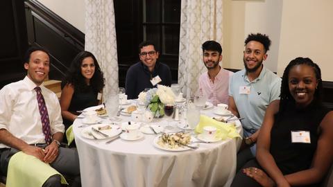 students and senior common room members sitting at a table