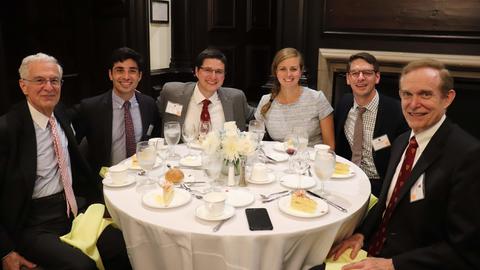 students and senior common room members sitting at a table