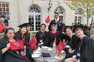 students around table waving Dunster flags